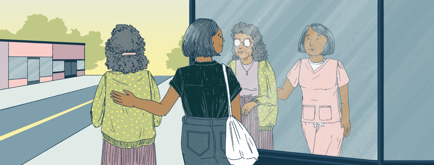 An older woman is guided down a sidewalk by a younger woman, her daughter. As they pass a store window, the reflection shows the pair, except in the reflection the younger woman is wearing scrubs.