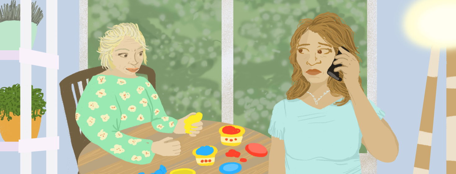 A caretaker calls a friend for help while looking over her mother, who is playing with clay at a nearby kitchen table.