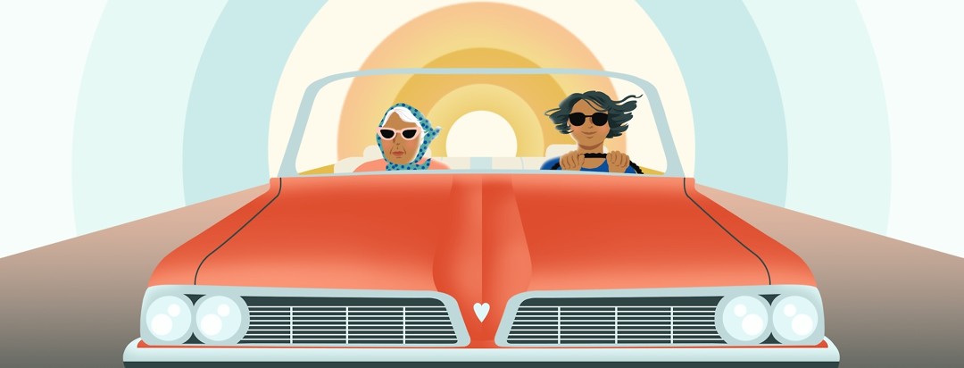 An elderly woman in sunglasses and a headscarf sits in the passenger seat of a classic convertible car while a younger woman drives.