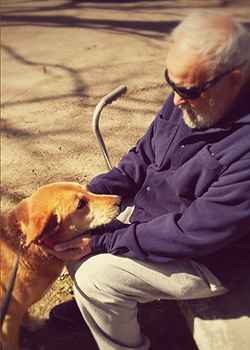 Alzheimer advocate Amy’s dad petting the dog, Layla, the two look at each other