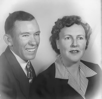 A seated portrait of a happy young couple in the late 1930s or early 1940s.