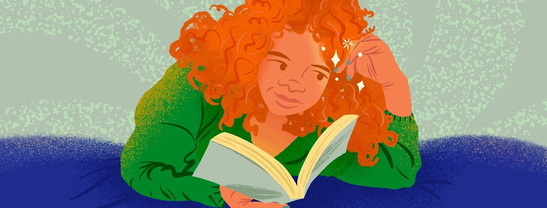 Woman with curly red hair reads book laying down, looking at her sparkling nails.