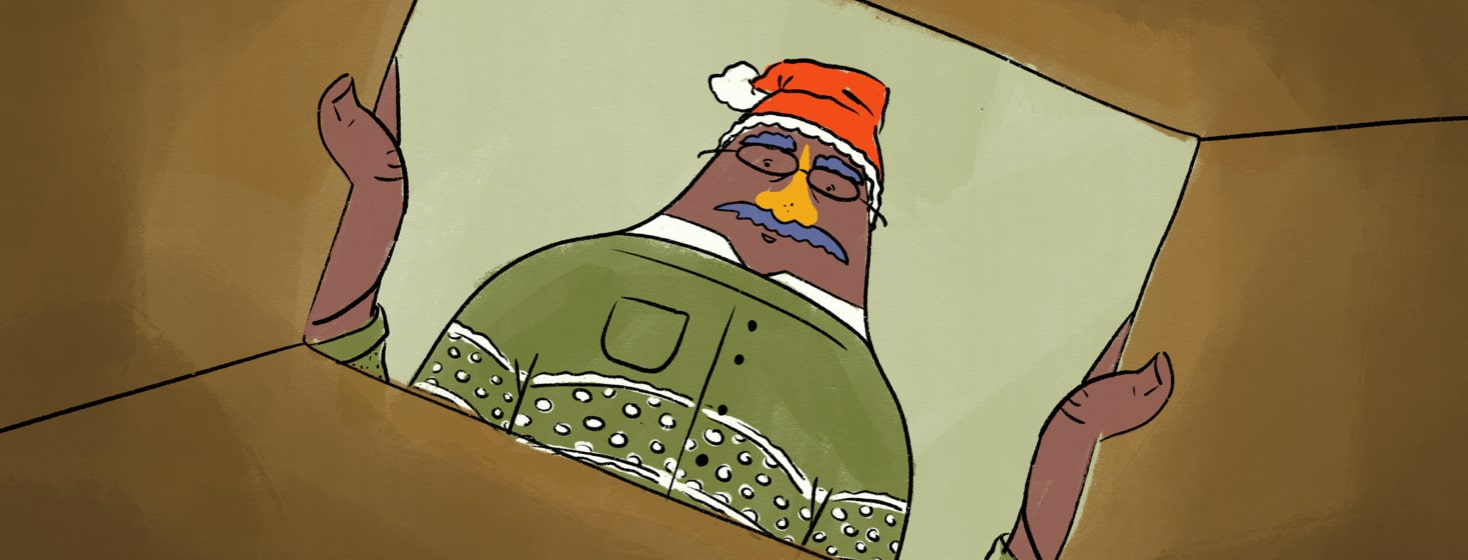 Man wearing a Santa hat looking into a box