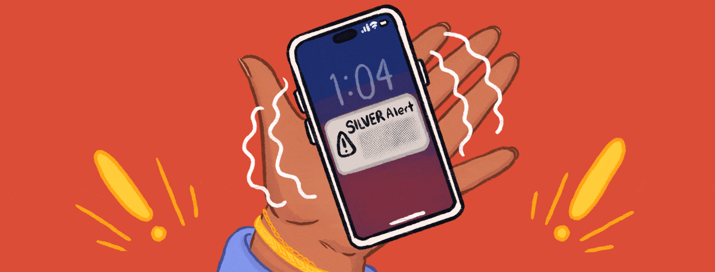 A hand holding a vibrating phone showing a Silver Alert on the screen